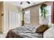 Bedroom with a plush bed, hanging plants, and natural light from the windows at 6012 Drave Ln, Fort Mill, SC 29715