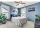 Comfortable bedroom with ample natural light, a cozy bed, and tasteful wall art at 6012 Drave Ln, Fort Mill, SC 29715