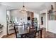 Open-concept dining area with dark wood table, stone fireplace, and access to living spaces at 6012 Drave Ln, Fort Mill, SC 29715