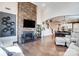 Open living space with stone fireplace, hardwood floors, and staircase at 6012 Drave Ln, Fort Mill, SC 29715