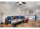 Warm living room showcasing hardwood floors, a sectional sofa with colorful throw pillows, and natural lighting at 6012 Drave Ln, Fort Mill, SC 29715