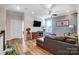Cozy living room with hardwood floors, a comfortable leather couch, and a wall-mounted TV at 6012 Drave Ln, Fort Mill, SC 29715