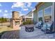Inviting outdoor patio with brick fireplace, seating area, and stylish outdoor rug at 6012 Drave Ln, Fort Mill, SC 29715