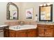 The primary bath boasts a jacuzzi tub nestled in oak paneled walls with tiled countertops at 21315 Blakely Shores Dr, Cornelius, NC 28031