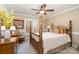 Bedroom with four poster bed, patterned fabrics, matching dressers, and a neutral color palette under a ceiling fan at 21315 Blakely Shores Dr, Cornelius, NC 28031