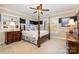 This primary bedroom features a four-poster bed, matching dressers and serene decor, with a blue and cream color scheme at 21315 Blakely Shores Dr, Cornelius, NC 28031