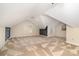Large bonus room features vaulted ceilings and neutral carpet with windows and a dark accent wall at 21315 Blakely Shores Dr, Cornelius, NC 28031