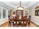 Elegant dining room with hardwood floors, detailed trim, and large chandelier at 21315 Blakely Shores Dr, Cornelius, NC 28031