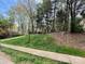 Lush green front lawn, accented by mature trees, provides a picturesque setting for the property at 21315 Blakely Shores Dr, Cornelius, NC 28031
