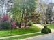 Lush green lawn and mature trees frame the property, offering privacy and curb appeal at 21315 Blakely Shores Dr, Cornelius, NC 28031