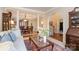 Open-concept living space with elegant columns, hardwood floors, and a view into the dining area at 21315 Blakely Shores Dr, Cornelius, NC 28031