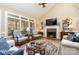 Cozy living room with fireplace, large windows, and hardwood flooring at 21315 Blakely Shores Dr, Cornelius, NC 28031
