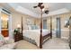 Spacious main bedroom offers a four-poster bed, tray ceiling, and view to the ensuite bathroom at 21315 Blakely Shores Dr, Cornelius, NC 28031