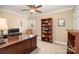 Home office with a large desk, ceiling fan, custom bookcase, and natural light at 21315 Blakely Shores Dr, Cornelius, NC 28031