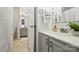 Bathroom with white countertop, gray cabinets, and decorative towels and plants at 3302 Selwyn Farms Ln, Charlotte, NC 28209