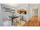 Modern dining area open to the kitchen with breakfast bar seating at 3302 Selwyn Farms Ln, Charlotte, NC 28209