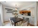 Modern dining area open to the kitchen featuring a stylish table and floating shelves at 3302 Selwyn Farms Ln, Charlotte, NC 28209