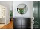 Bright entryway featuring a round mirror and sleek storage cabinet at 3302 Selwyn Farms Ln, Charlotte, NC 28209