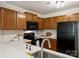 Cozy kitchen with wood cabinets, black appliances, and white subway tile backsplash at 3302 Selwyn Farms Ln, Charlotte, NC 28209