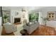Cozy living room with a brick fireplace, built-in shelves, and access to a balcony at 3302 Selwyn Farms Ln, Charlotte, NC 28209