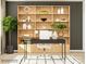 Home office with large wooden shelving unit and black desk at 4068 Skyboat Cir, Fort Mill, SC 29715
