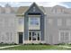 Two-story home with blue and beige siding, landscaping, and a dark-colored door at 4499 Potters Wheel Dr, Fort Mill, SC 29715