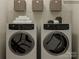 Modern laundry room with washer, dryer, and storage at 4499 Potters Wheel Dr, Fort Mill, SC 29715
