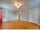 Spacious bedroom featuring hardwood floors and built-in closet at 6815 Castlegate Dr, Charlotte, NC 28226