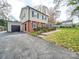 Brick and siding house with attached garage and a well-maintained yard at 6815 Castlegate Dr, Charlotte, NC 28226