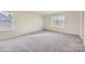 Spacious bedroom with neutral carpeting and large window at 123 Dogwood Grove Pl, Troutman, NC 28166