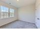 Bright bedroom with two windows and grey carpet at 123 Dogwood Grove Pl, Troutman, NC 28166