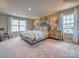 Main bedroom with plush bed, stylish dresser, and large windows at 123 Dogwood Grove Pl, Troutman, NC 28166