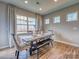 Bright dining room features a wood table, bench, and chairs, with large windows at 123 Dogwood Grove Pl, Troutman, NC 28166