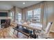 Spacious dining area with a wooden table and bench, offering ample natural light at 123 Dogwood Grove Pl, Troutman, NC 28166