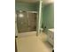 Mint green bathroom with shower/tub combo and white vanity at 323 Breslin St, Wadesboro, NC 28170