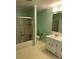 Bathroom with shower/tub combo, white vanity, and mint green walls at 323 Breslin St, Wadesboro, NC 28170