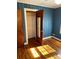 Bedroom featuring hardwood floors, blue walls and closet with mirror at 323 Breslin St, Wadesboro, NC 28170