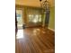 Hardwood floor dining room with green walls and a view of the front yard at 323 Breslin St, Wadesboro, NC 28170