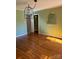 Bright dining room with hardwood floors and unique light fixtures at 323 Breslin St, Wadesboro, NC 28170