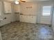 Laundry room with tile flooring, cabinets, and exterior access at 323 Breslin St, Wadesboro, NC 28170