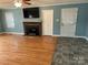 Living room with hardwood floors, fireplace, and built-ins at 323 Breslin St, Wadesboro, NC 28170