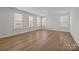 Large bright bedroom featuring hardwood floors, three large windows, and neutral walls at 622 Amberjack Pl, York, SC 29745