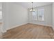 Bright dining room featuring a chandelier, hardwood floors, and a neutral color palette at 622 Amberjack Pl, York, SC 29745