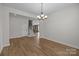 Open-concept dining room with hardwood floors, chandelier, and view to kitchen and staircase at 622 Amberjack Pl, York, SC 29745