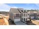 Stylish gray home featuring a two-story design with a balcony, garage, and a well-manicured lawn at 622 Amberjack Pl, York, SC 29745