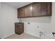 Laundry room featuring a sink, cabinetry, and tile floors at 622 Amberjack Pl, York, SC 29745