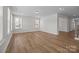 Bright living room with wood floors and large windows creating an inviting and spacious atmosphere at 622 Amberjack Pl, York, SC 29745