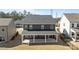 Back view of a two story home featuring a covered porch and fenced yard at 622 Amberjack Pl, York, SC 29745