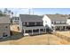 Back view of a two story home featuring a covered porch and fenced yard at 622 Amberjack Pl, York, SC 29745