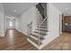 Elegant staircase with wood treads, wrought iron railings, and open floor plan design at 622 Amberjack Pl, York, SC 29745